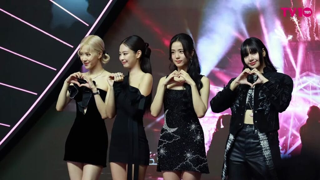 BLACKPINK performing their hit songs live on stage during their 2026 world tour with high-energy choreography.