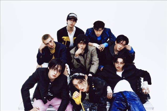 Stray Kids members Bang Chan, Lee Know, Changbin, Hyunjin, Han, Felix, Seungmin, and I.N posing for a professional group photoshoot.